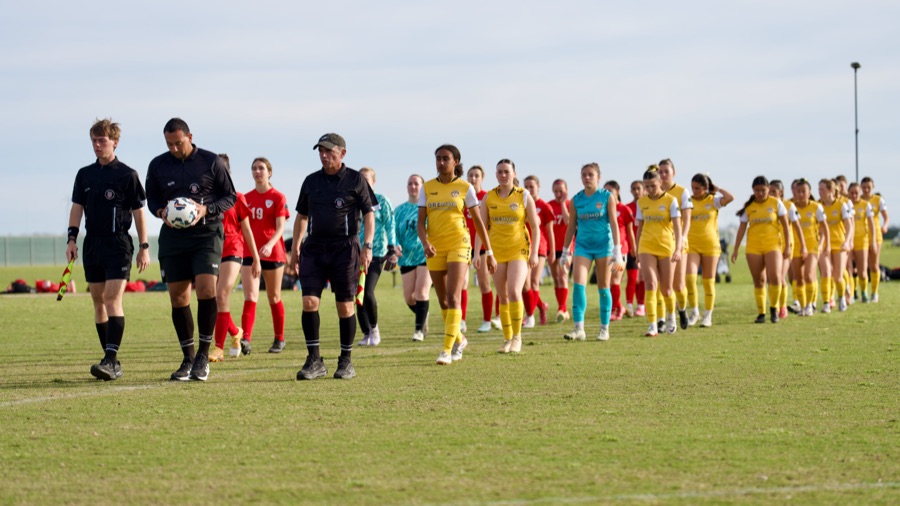 team walking with referees and players